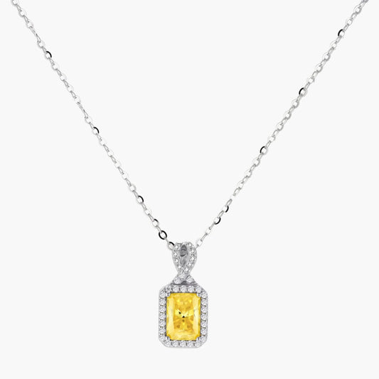 Yellow moissanite jewelry set with emerald-cut stones in sterling silver halo settings on white background.