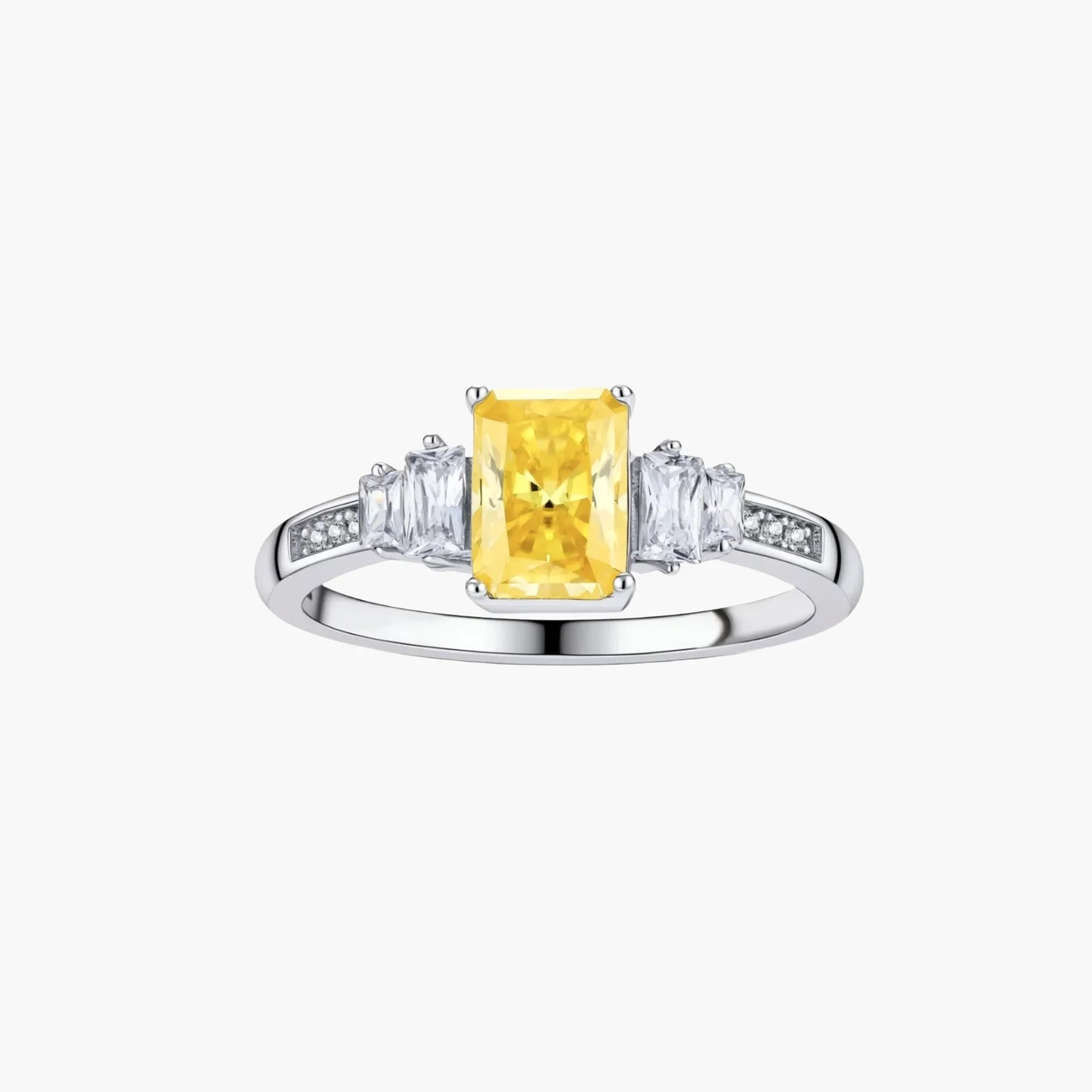 Yellow moissanite jewelry set with emerald-cut stones in sterling silver halo settings on white background.