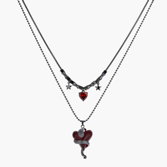 Dark layered necklace set with black chains and red heart pendants, featuring gothic snake design on white background