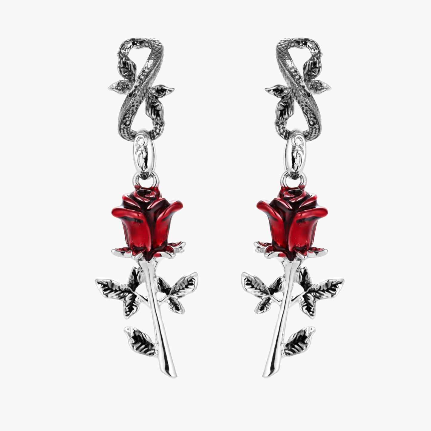 Gothic dangle earrings featuring silver serpent hooks with red enamel roses and metallic stems on white background.