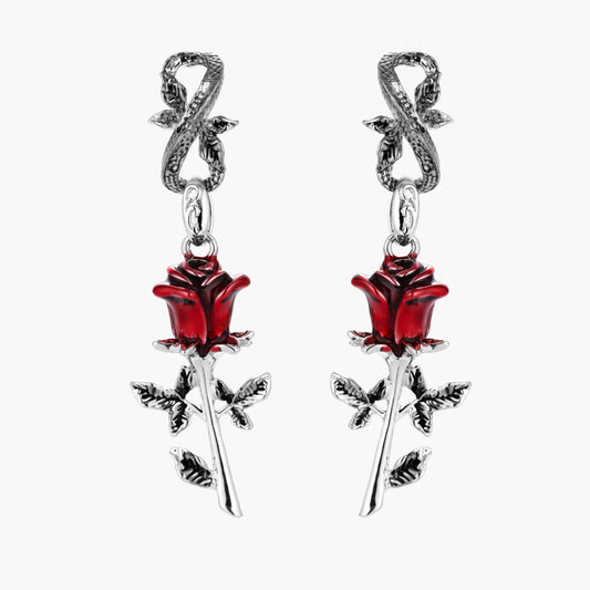 Gothic dangle earrings featuring silver serpent hooks with red enamel roses and metallic stems on white background.