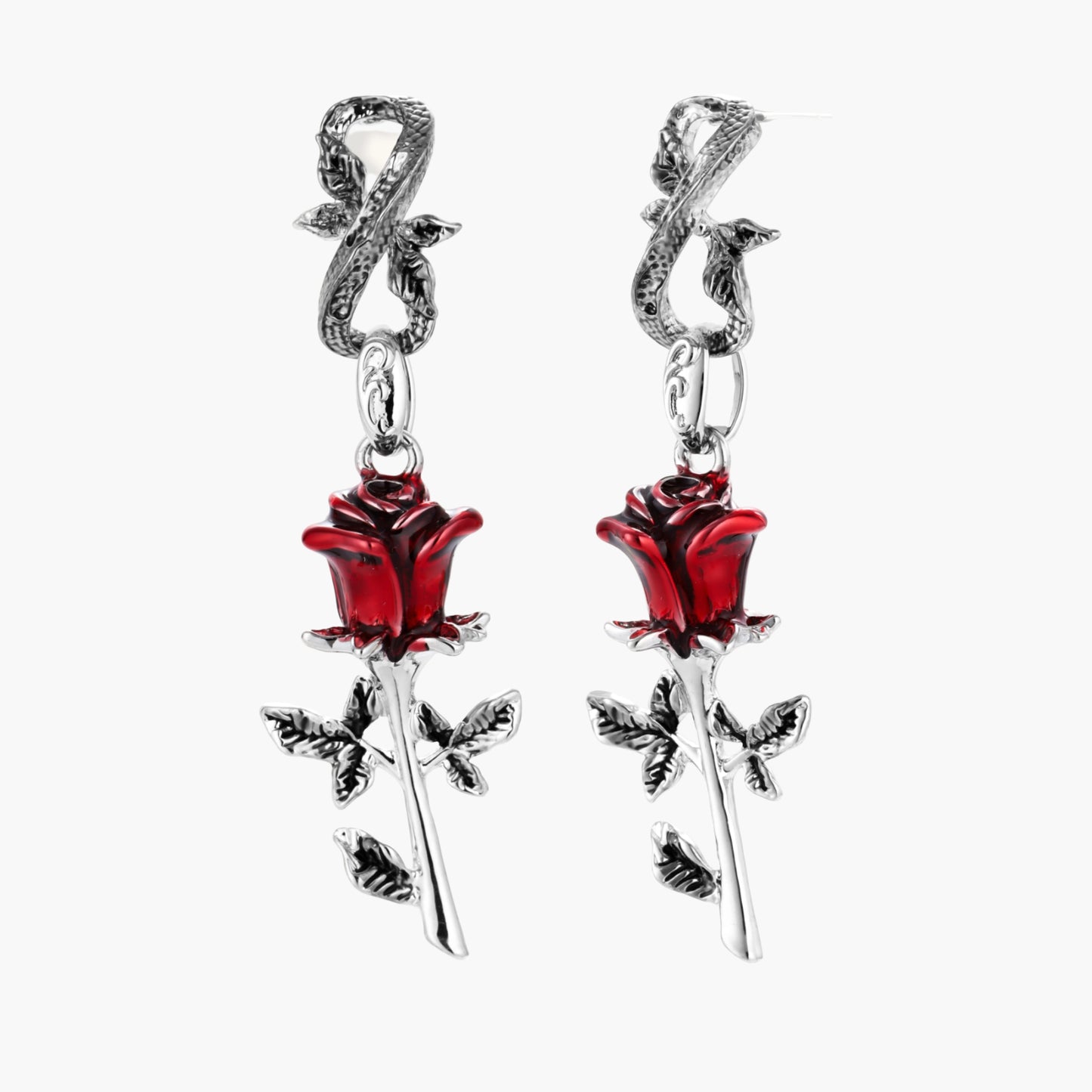 Gothic dangle earrings featuring silver serpent hooks with red enamel roses and metallic stems on white background.