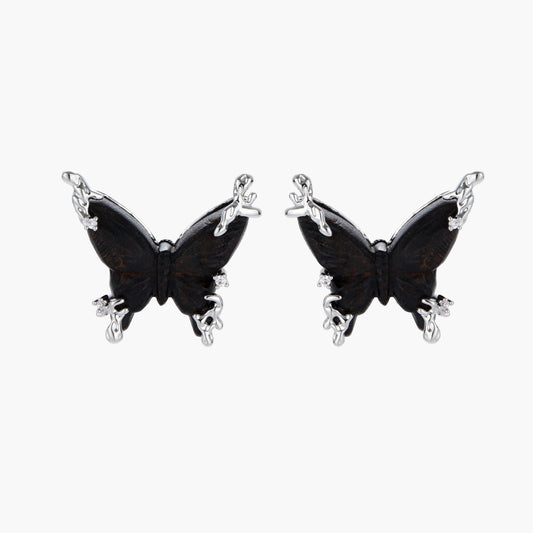 Wooden butterfly earrings with silver chain details in light and dark wood variants on white background