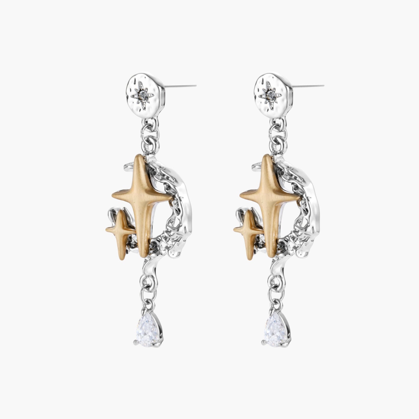 Two-tone star earrings with gold celestial motifs, silver chains, and clear crystal droplets on white background.