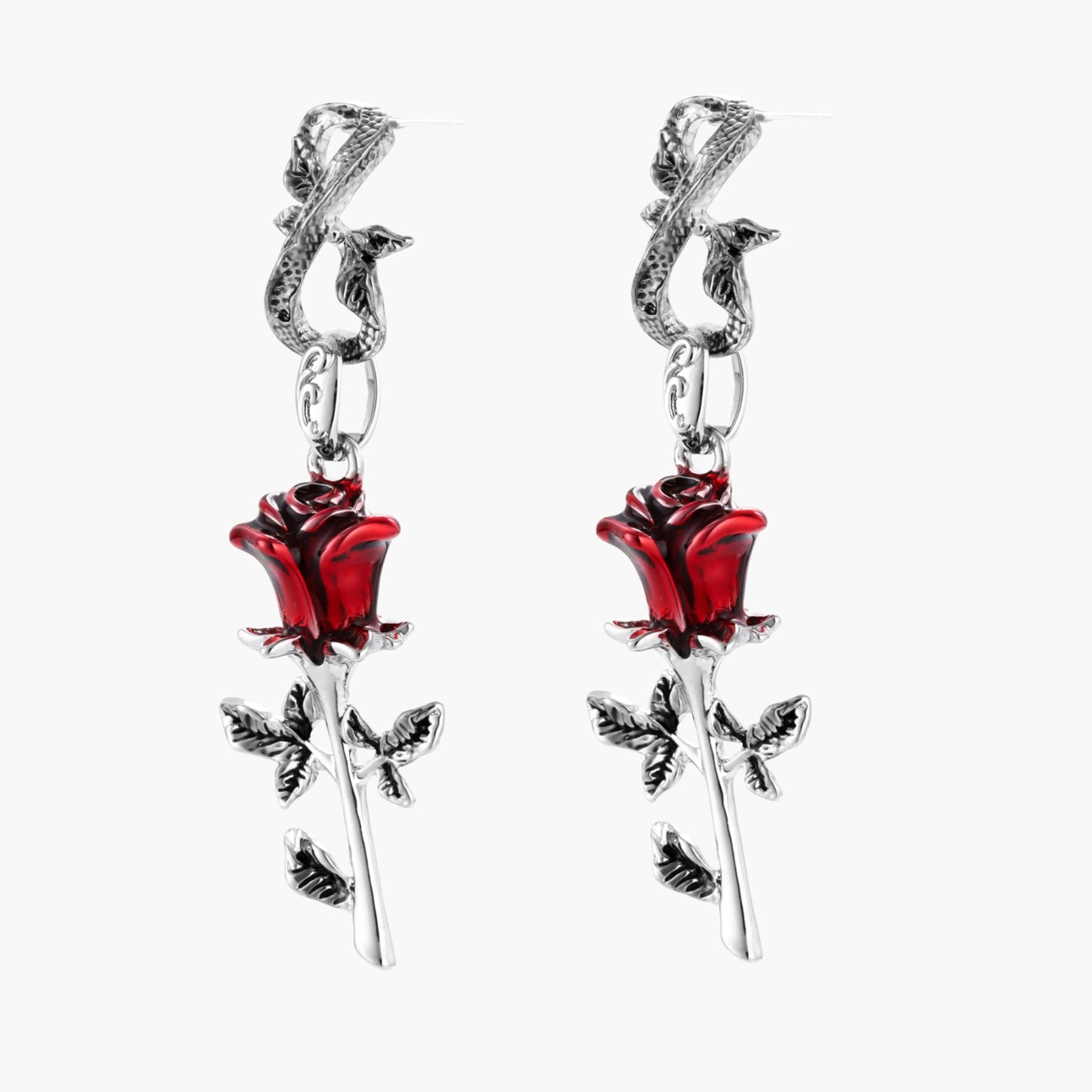 Gothic dangle earrings featuring silver serpent hooks with red enamel roses and metallic stems on white background.