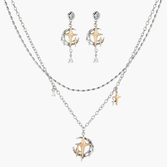 Delicate eco-brass jewelry set featuring gold star and silver moon crescents with clear zirconia crystal drops on cream background