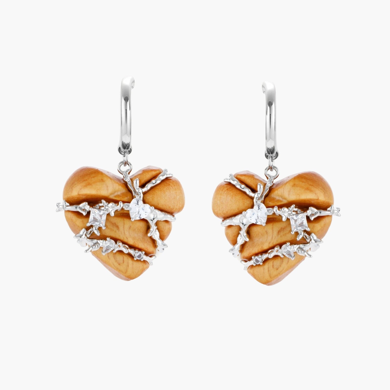 Heart-shaped wood earrings wrapped in silver wire with zirconia crystals, featuring ball stud posts on white background.