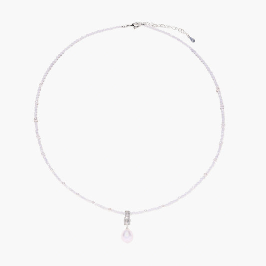 Dainty necklace with lavender crystal beads, freshwater pearls, geometric pendant, and large pearl drop on white background.