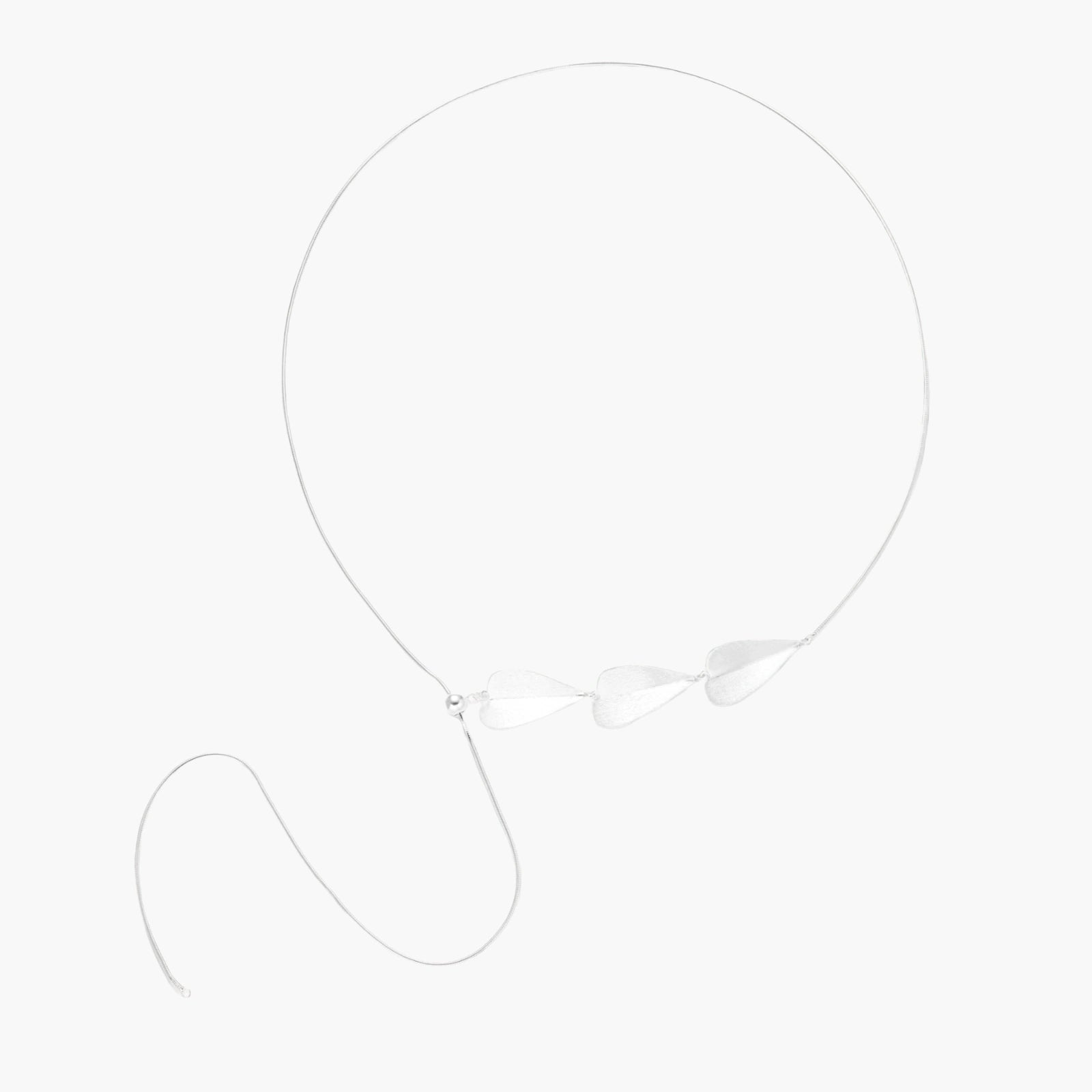 Minimalist sterling silver necklace with three brushed leaf-shaped pendants on delicate chain against white background