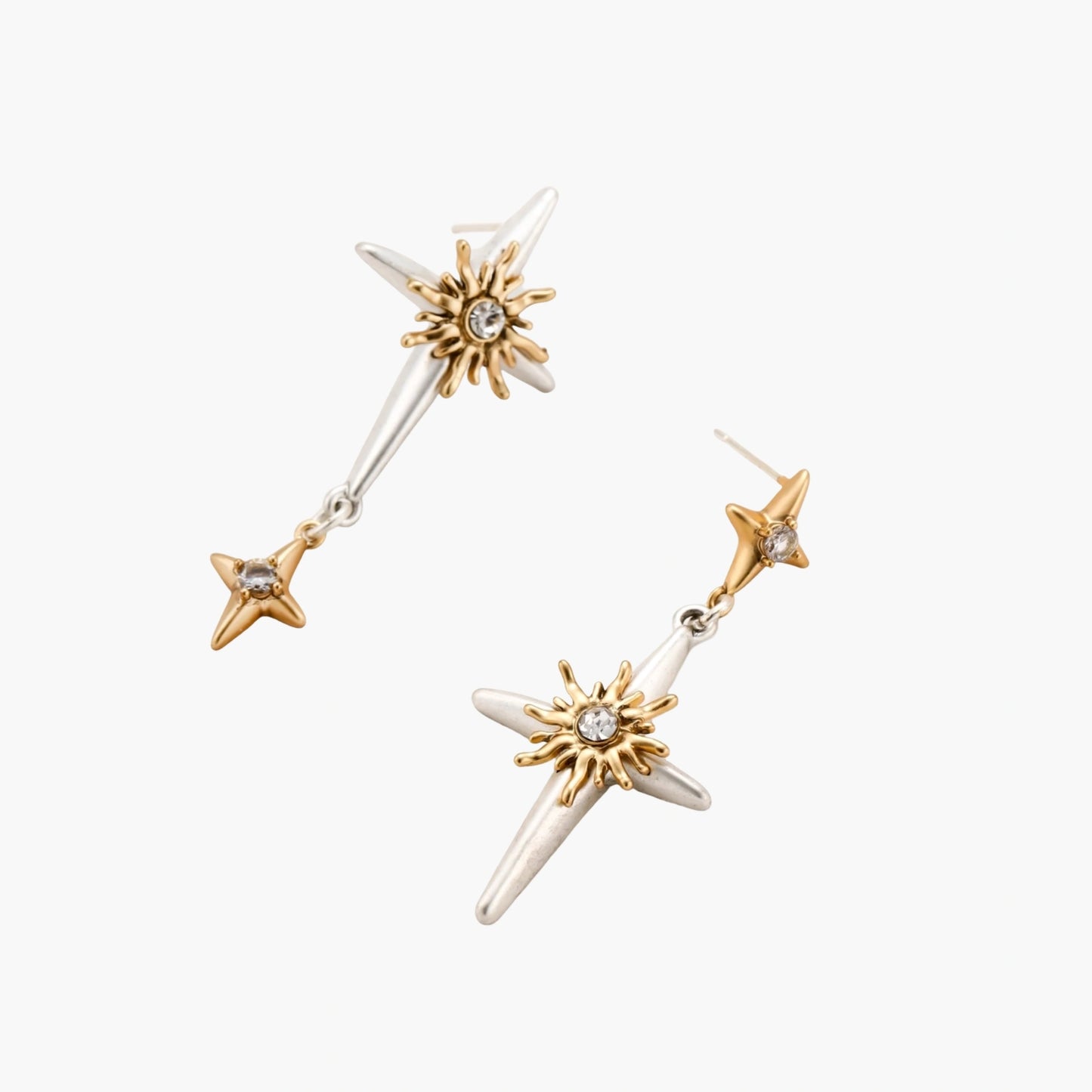 Layered silver-toned necklace set with cross pendant and gold sun charm detail, matching drop earrings on white background.