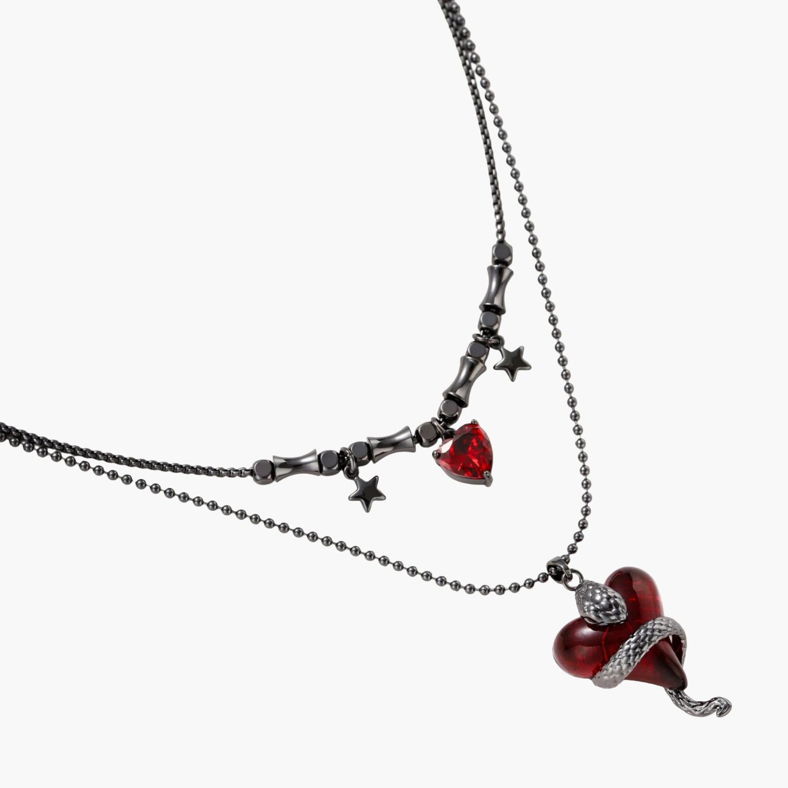 Gothic jewelry set with asymmetrical black metal earrings featuring red crescent moons, stars, and layered necklaces with heart pendants