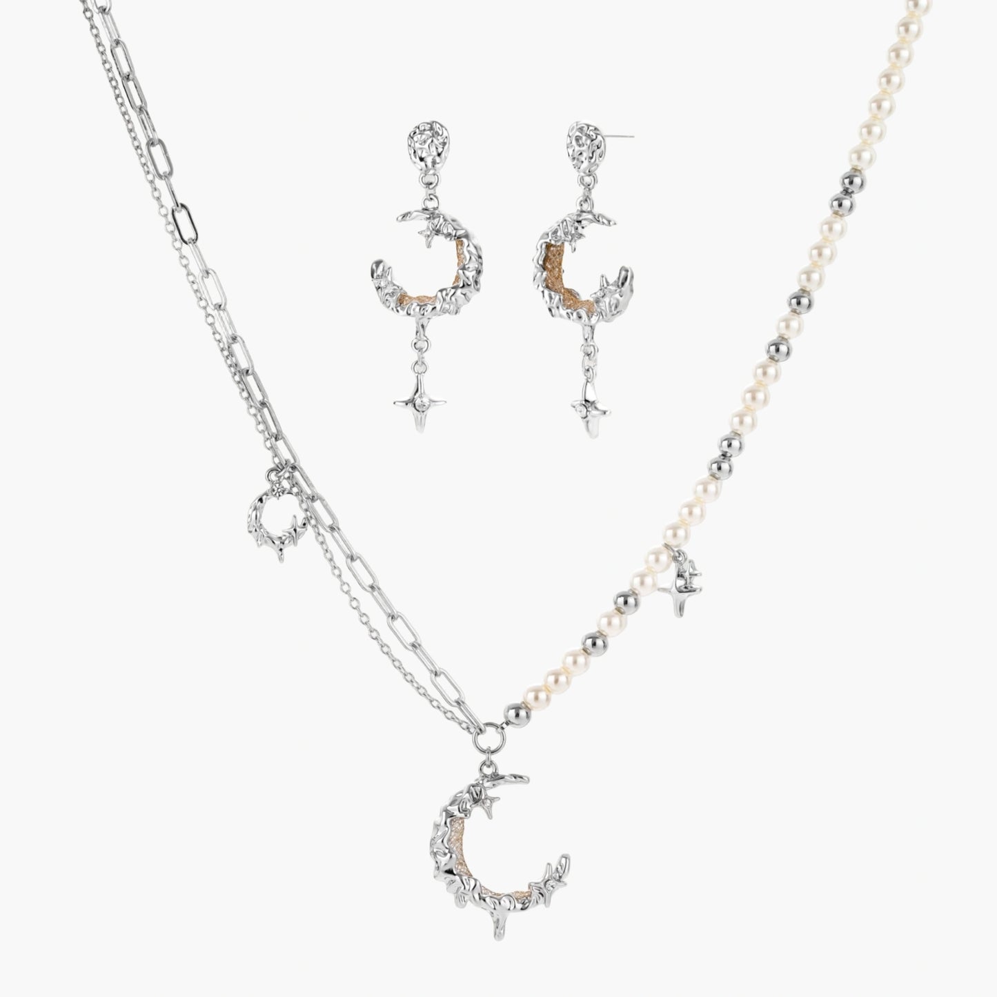 Mixed-metal jewelry set featuring layered necklaces with crescent moon pendant and pearl beads, plus matching star-drop earrings.