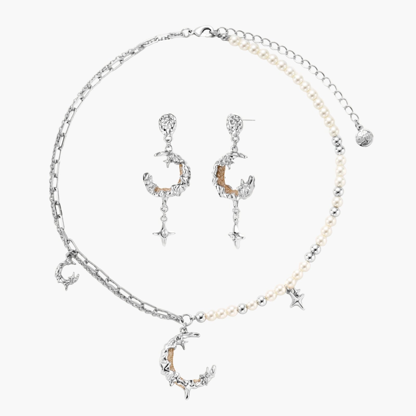 Mixed-metal jewelry set featuring layered necklaces with crescent moon pendant and pearl beads, plus matching star-drop earrings.