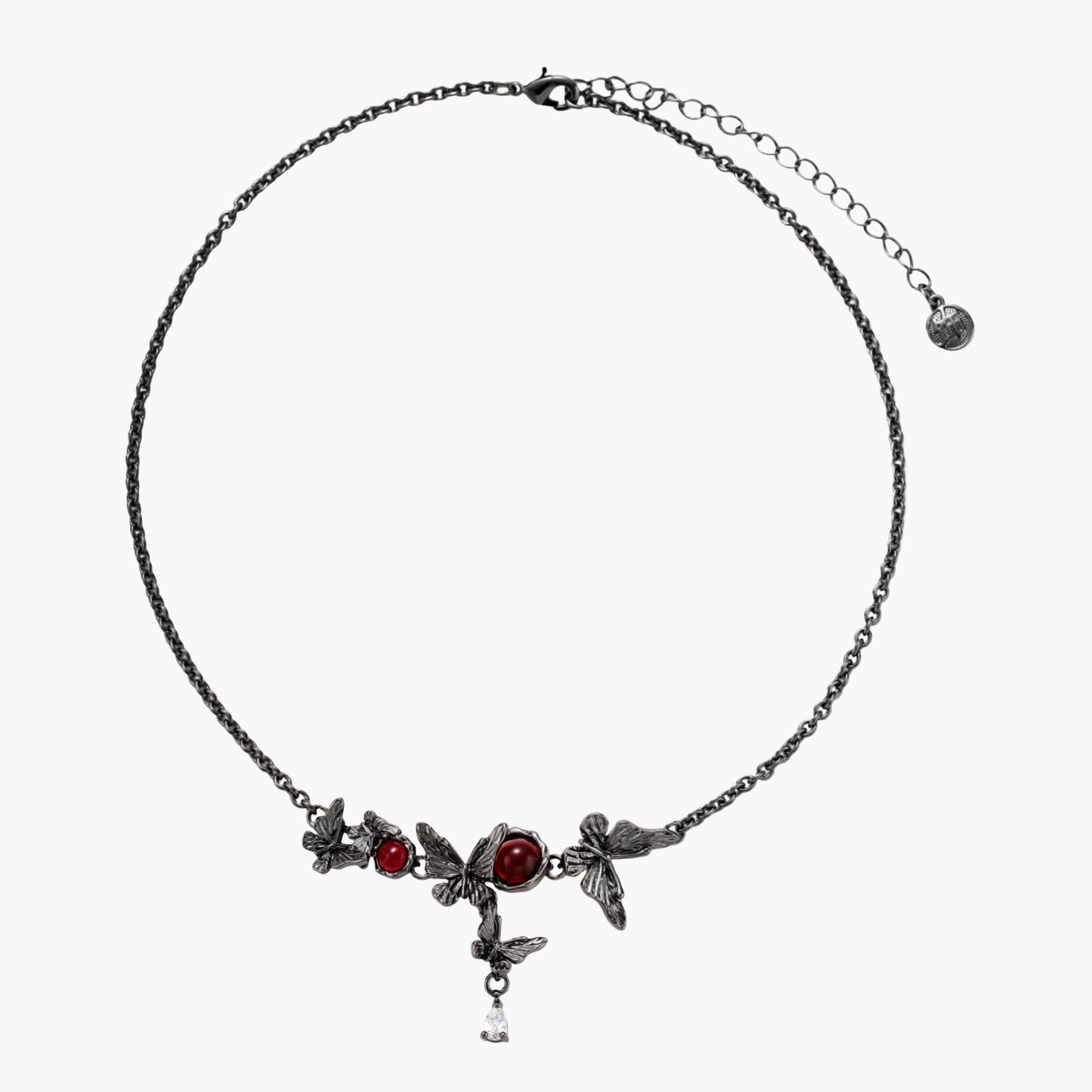 Dark oxidized metal necklace featuring red resin stones set in decorative leaf vine design with crystal drop pendant.