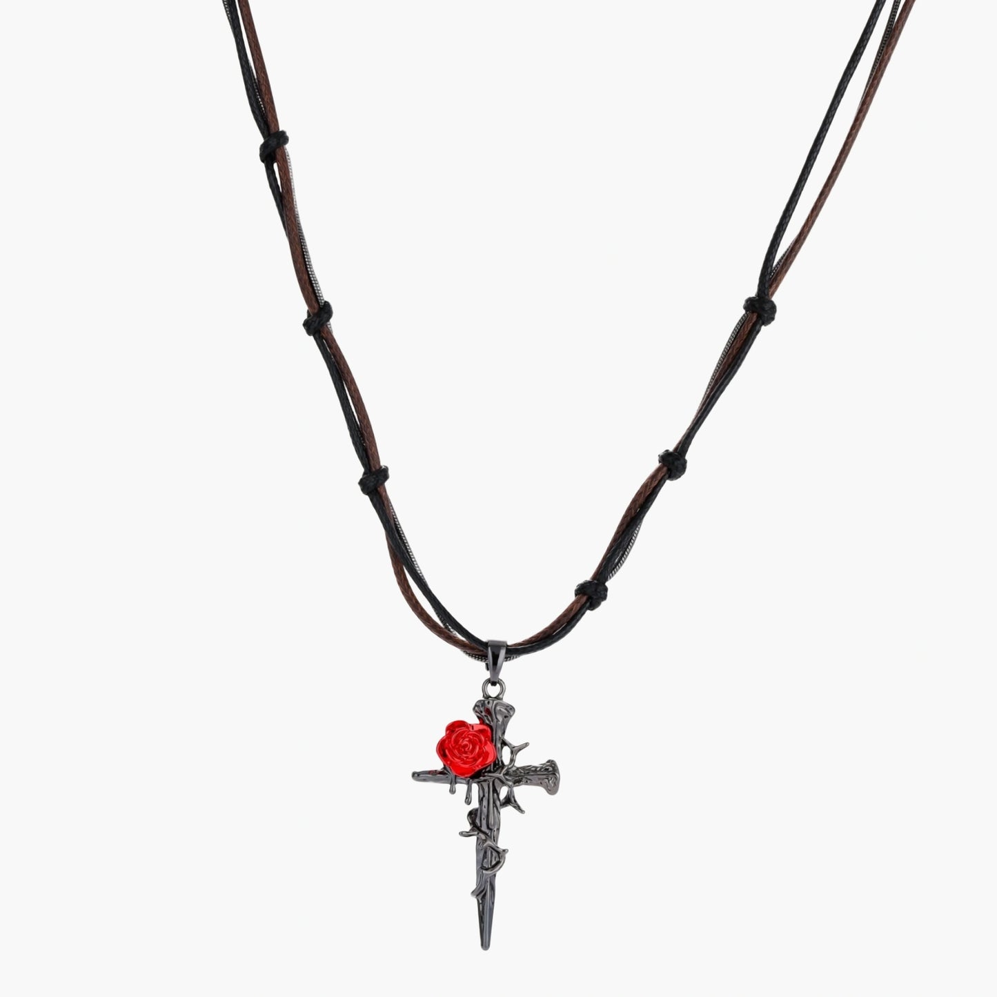 Gothic cross pendant with red enamel rose and thorn details on adjustable brown cord necklace against white background.