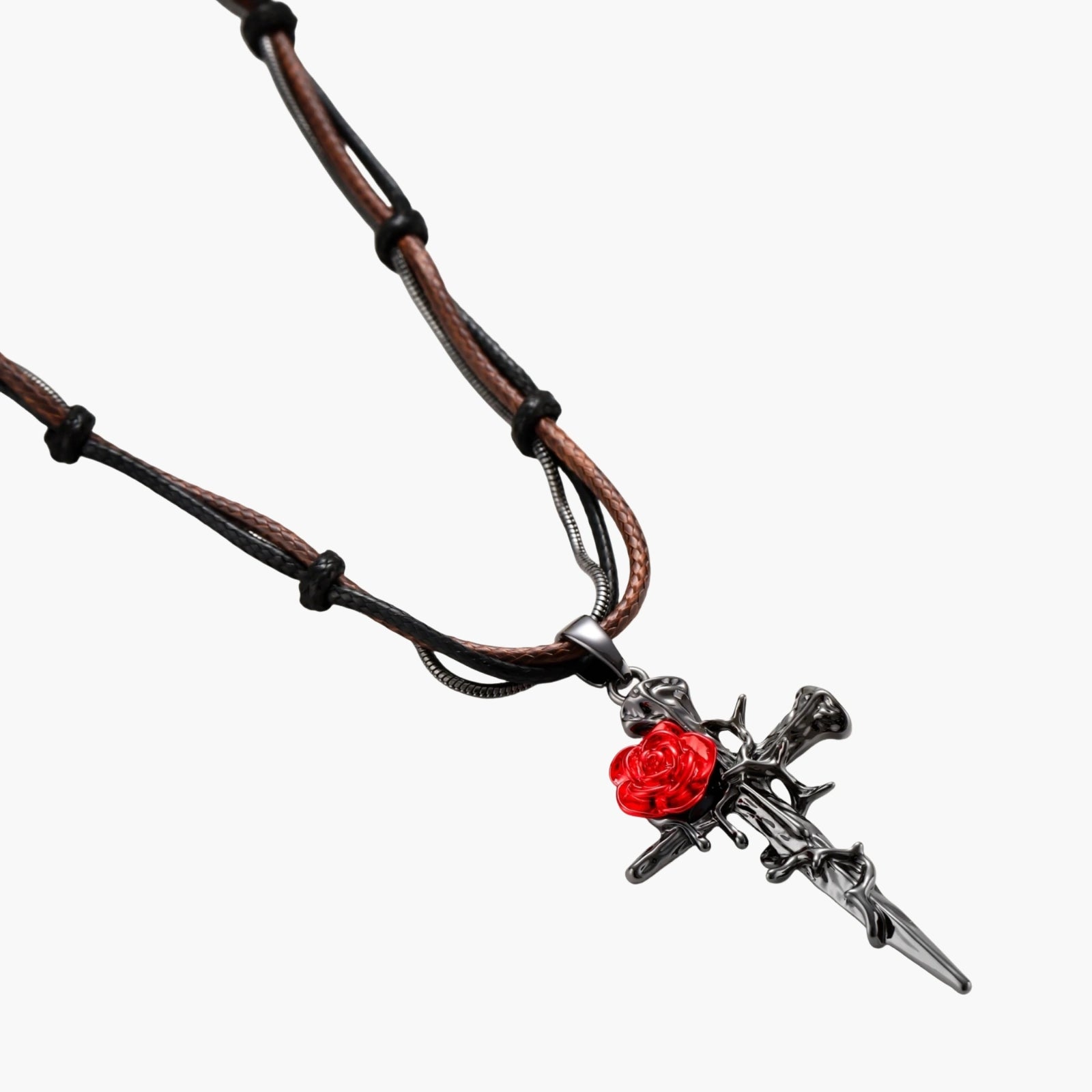 Gothic cross pendant with red enamel rose and thorn details on adjustable brown cord necklace against white background.