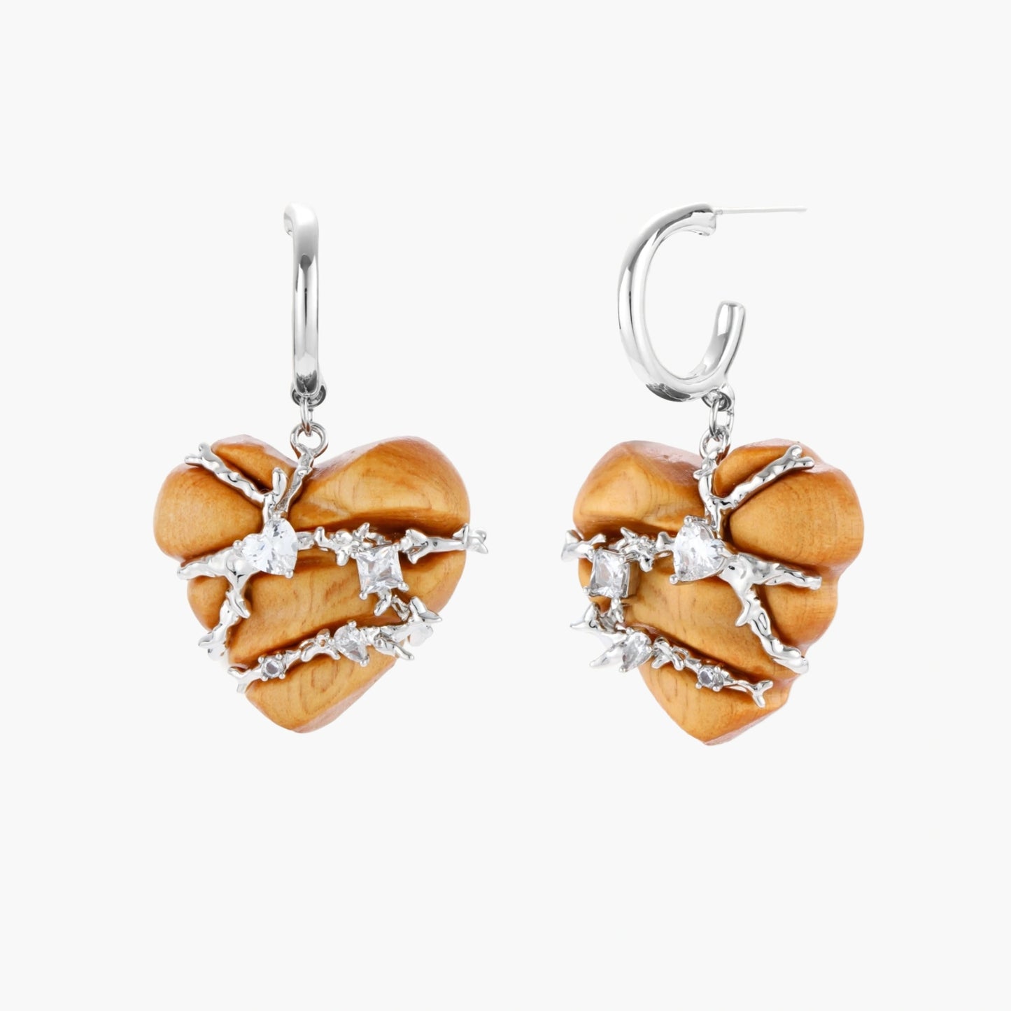 Heart-shaped eco-brass and wood jewelry set with silver wire detailing and crystal accents on cream background.